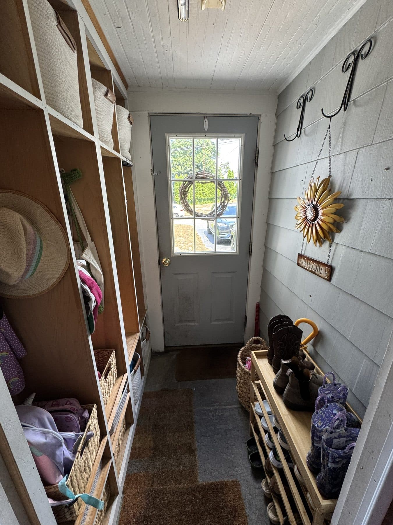 Calm, organized mudroom entryway after an IZEN organizing session
