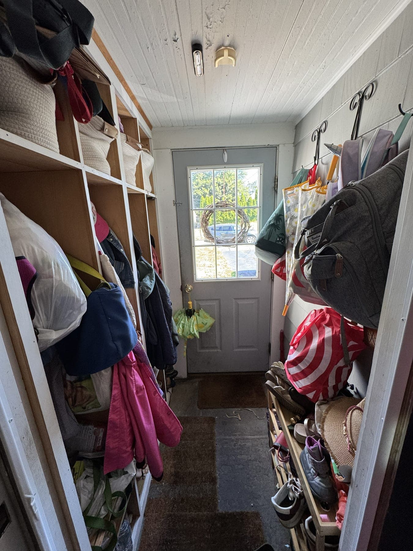 Cluttered mudroom entryway before IZEN decluttering and organization