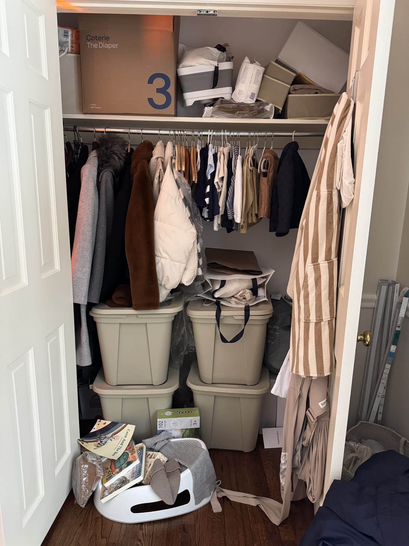 Baby closet crowded with boxes before organization