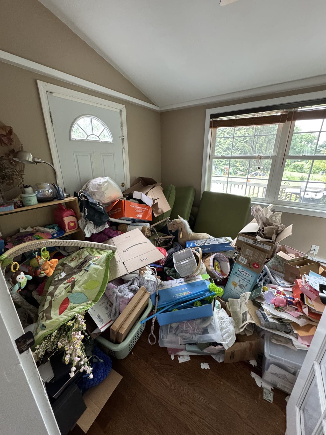 Playroom buried under toys, boxes, and clutter before IZEN decluttering