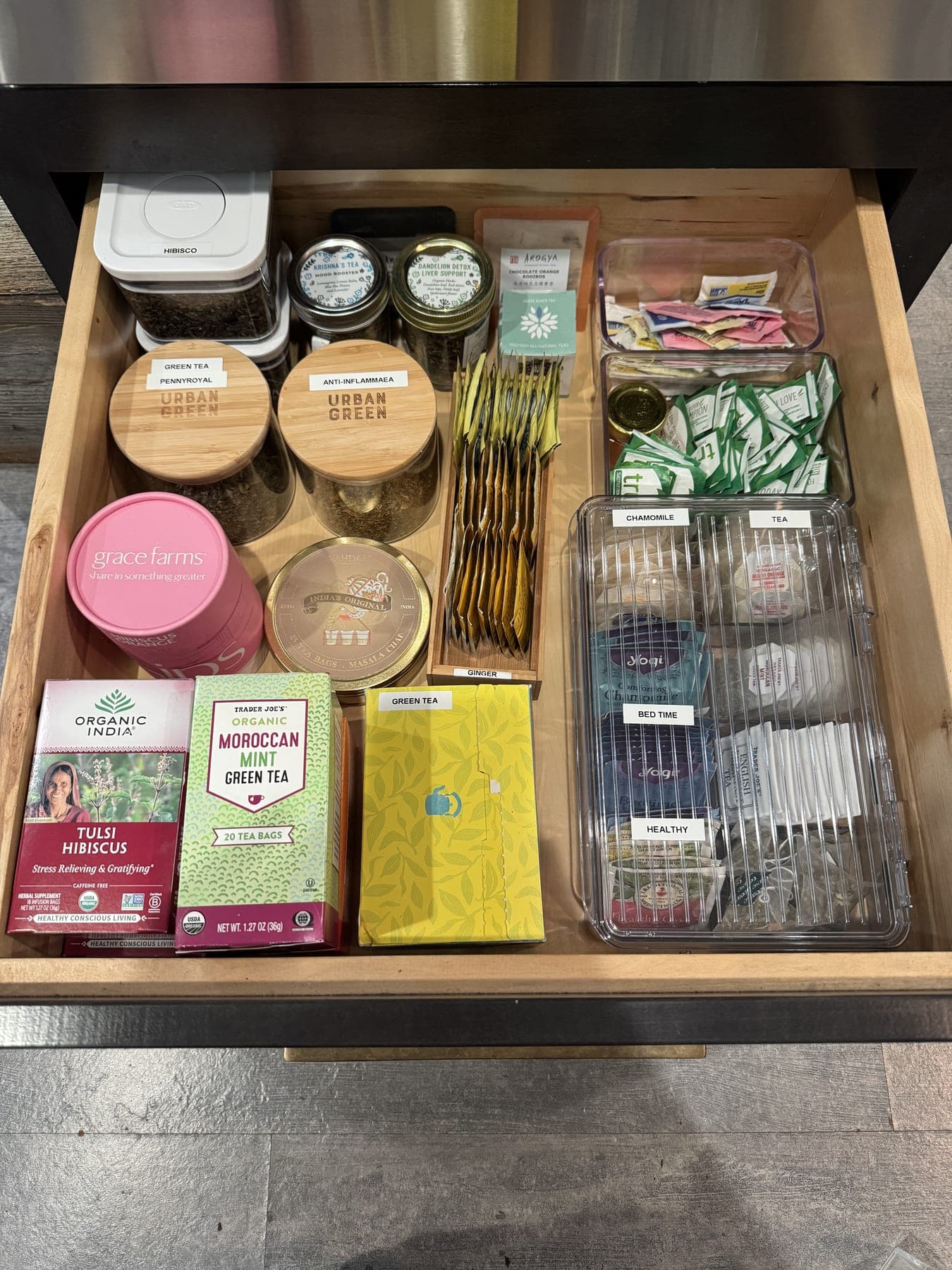 Tea drawer neatly arranged with jars and labeled compartments after an IZEN session