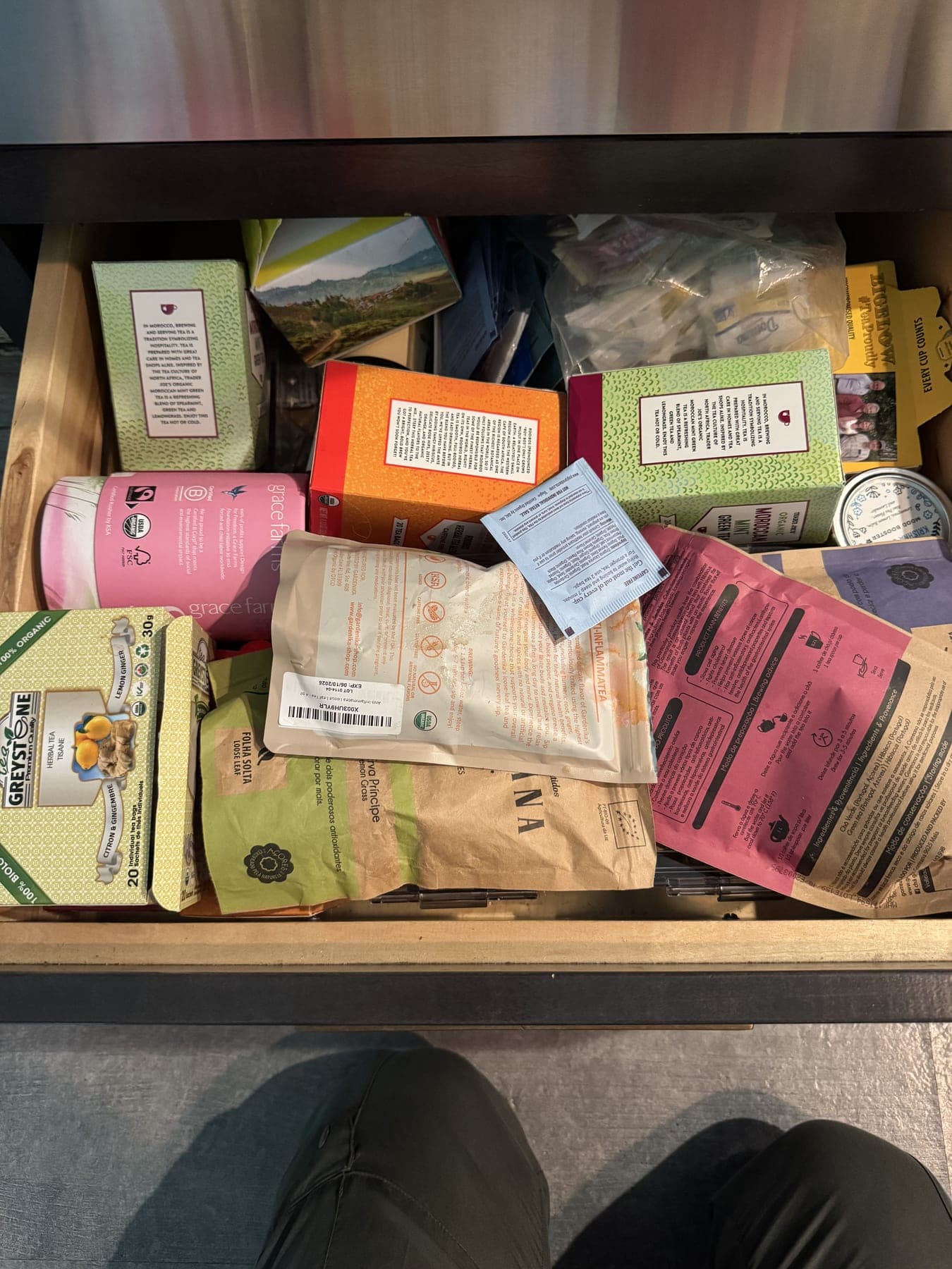 Kitchen drawer overflowing with loose tea boxes and bags before organization